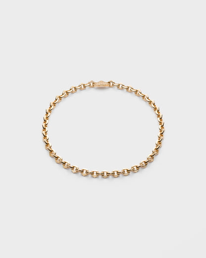 Gold chain bracelet on a light gray background